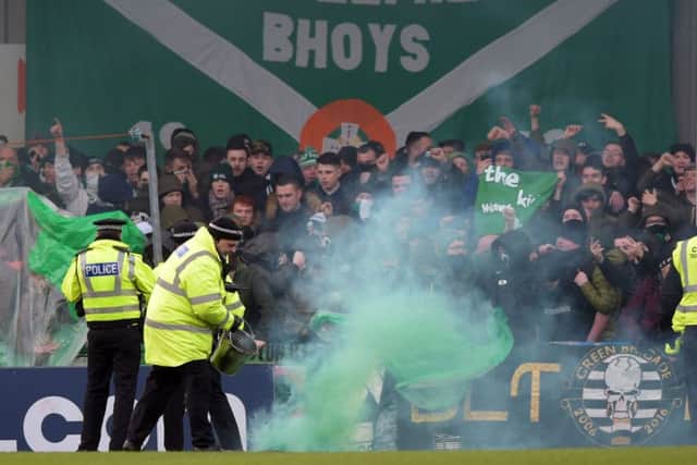 Police and stewards try to restore order at Stair Park yesterday as some Celtic supporters let off flares. Picture: SNS Group