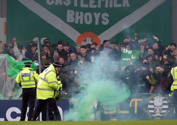 Police and stewards try to restore order at Stair Park yesterday as some Celtic supporters let off flares. Picture: SNS Group