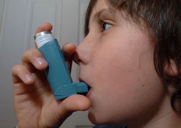 Photo of a boy using an inhaler for the treatment of Asthma.