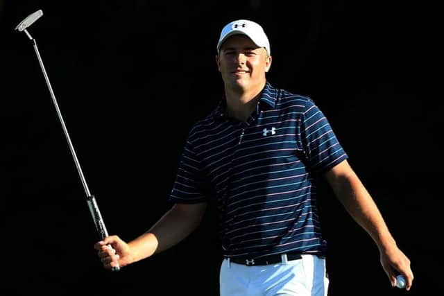 Jordan Spieth smiles after holing his birdie putt on the 15th at Kapalua Golf Club yesterday. Picture: Getty