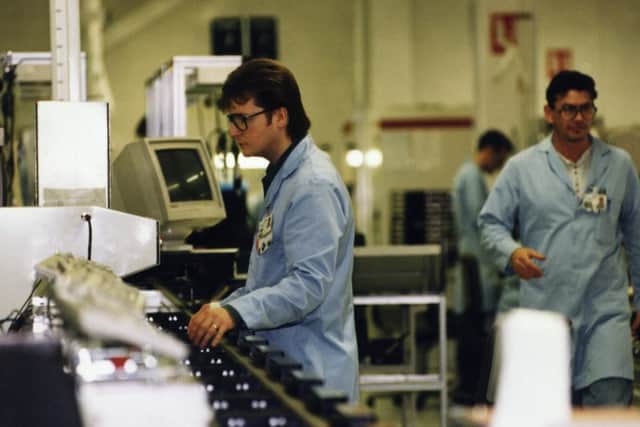A man working on the production line in the Assembly Area of Motorola.