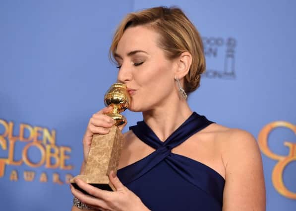 Kate Winslet poses in the press room with the award for best performance by an actress in a supporting role for Steve Jobs. Picture: AP