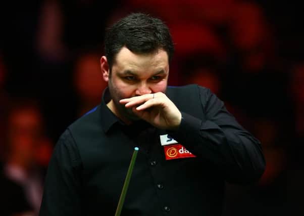 Stephen Maguire studies the table during his match against Judd Trump yesterday. Picture: Getty