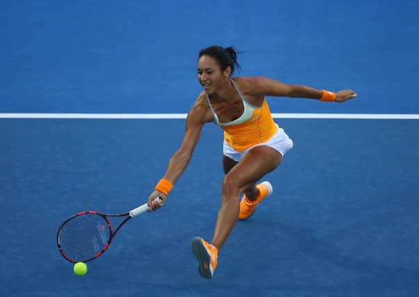Heather Watson plays a forehand during her first-round match against Teliana Pereira yesterday. Picture: Getty