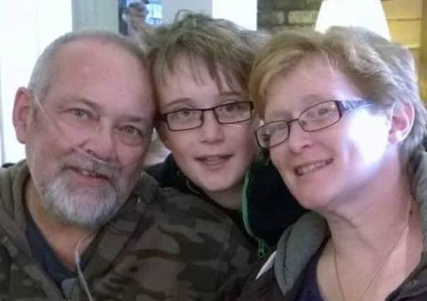 Keith Douglas, left, with his son Scott and wife Karen