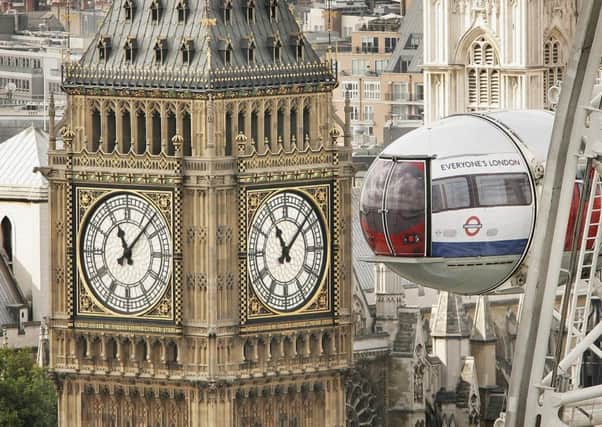 A pod on the London Eye ferris wheel, dressed up to look like an underground train, is seen in front of Big Ben. Picture: Getty Images