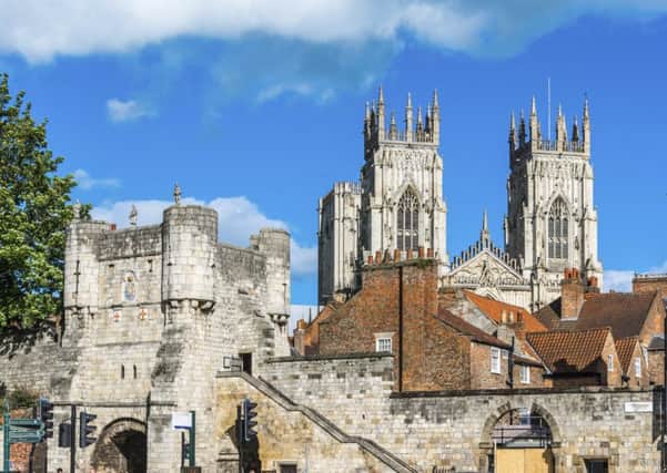 A view of Yorks medieval gate, tower and Minster in the background