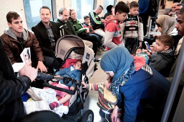Migrants prepare to leave Copenhagen for Sweden by train. On Tuesday the government won a majority to alter legislation  on migrants assets. Picture: AFP/Getty Images