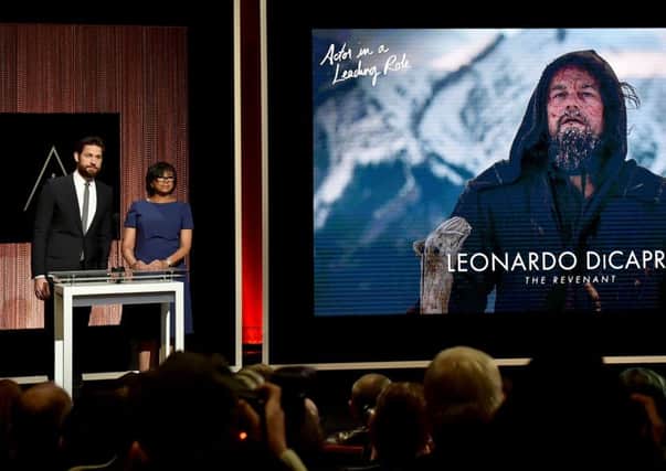 Actor John Krasinski and President of the Academy of Motion Picture Arts and Sciences Cheryl Boone Isaacs announce Leonardo DiCaprio as a nominee for Best Actor. Picture: Getty Images