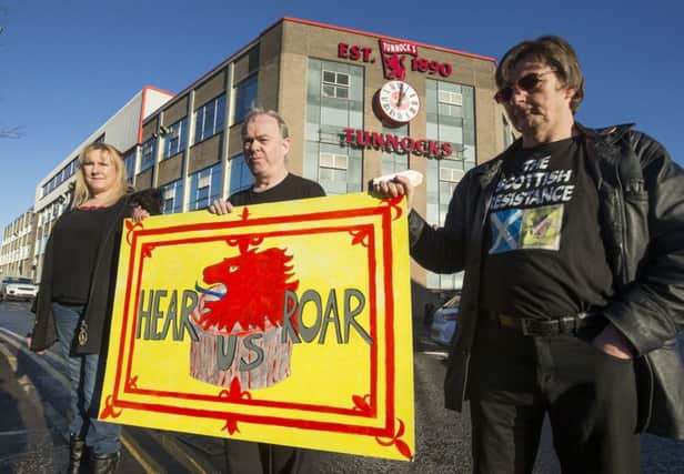 Scottish Resistance activists (left to right) Gwen Sinclair, Sean Clerkin and James Scott protest outside Tunnock's factory in Uddingston. Picture: PA