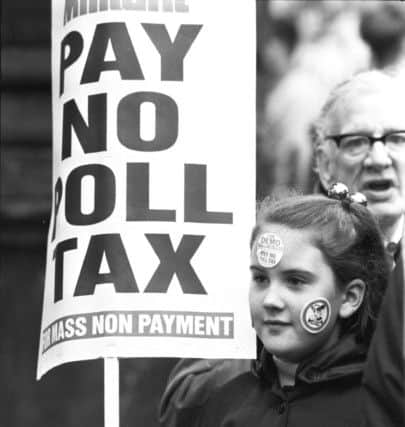 A girl demonstrates with a placard during an anti-poll tax march in Glasgow. Image: Stephen Mansfield