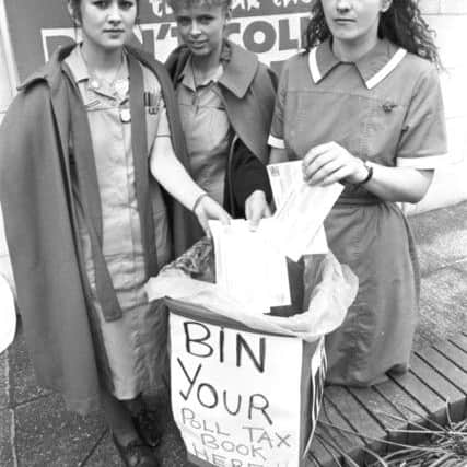 Edinburgh nurses (not identified) bin their poll tax books in a demonstration under the banner of the Federation of Edinburgh Anti Poll Tax Groups in June 1989. Image: Crauford Tait