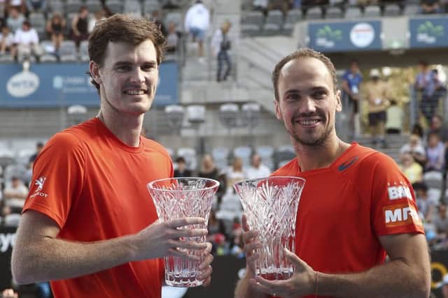 Scotland's Jamie Murray and Bruno Soares of Brazil with the men's doubles trophies after their win in the final at the Sydney International. Picture: Rob Griffith/AP