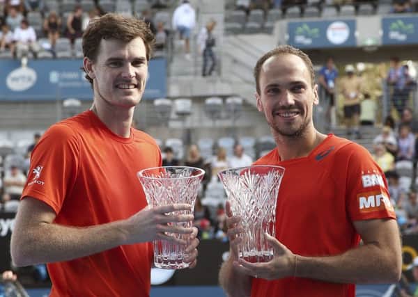 Scotland's Jamie Murray and Bruno Soares of Brazil with the men's doubles trophies after their win in the final at the Sydney International. Picture: Rob Griffith/AP