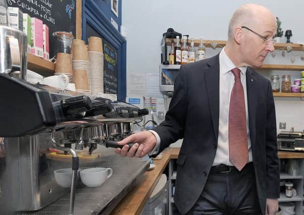 John Swinney helps with the teas and coffees during a visit to Living Wage employer Rabbies Tours. Picture: Neil Hanna