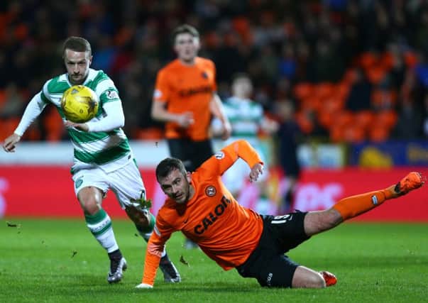 Gavin Gunning (falling over) is a weak link in the United defence but Leigh Griffiths had a fine game. Picture: Getty