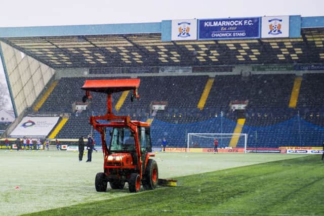 The Tractor Boys? Kilmarnock had help to clear the artificial turf at Rugby Park... Picture: SNS Group