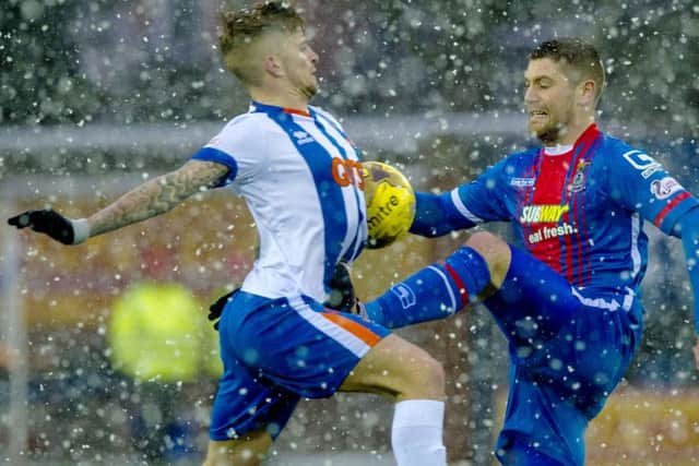 A robust challenge from Iain Vigurs on Kilmarnock goal hero Craig Slater. Picture: SNS Group