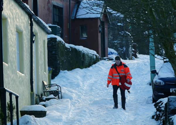 A postie gingerly makes his way down a hill in the Lanarkshire town of Leadhill. Picture: Hemedia