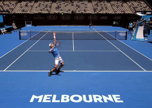 Andy Murray serves during a practice session in Melbourne on Saturday and takes a breather while he contemplates taking on Alexander Zverev in the first round of the Australian Open tomorrow. Picture: AP