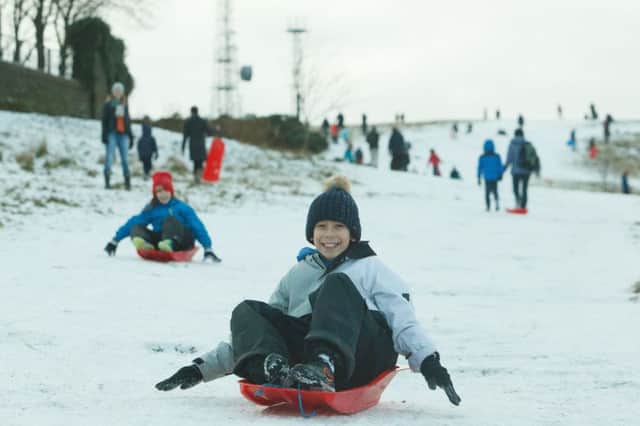 Families made the most of the snow with sledges at the Royal Observatory, Calton Hill in Edinburgh yesterday  more is forecast for this week. Picture: Toby Williams
