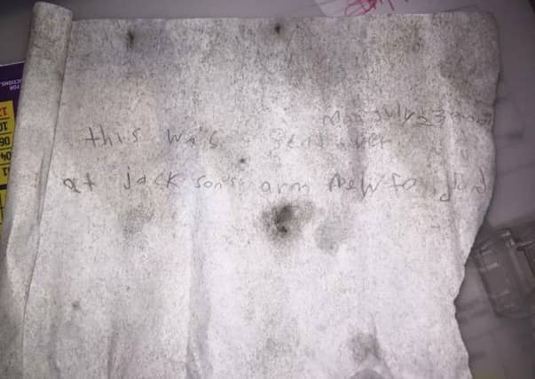 The faint writing on the message has survived over eight years adrift at sea. Image: Jason Tolmie