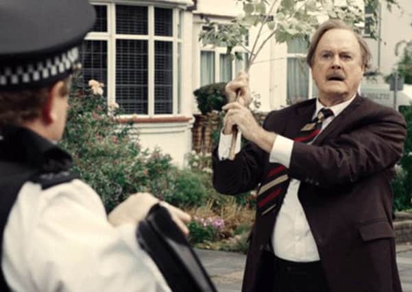 John Cleese gives another car a damn good thrashing with a tree branch, mimicking the famous Fawlty Towers scene.
