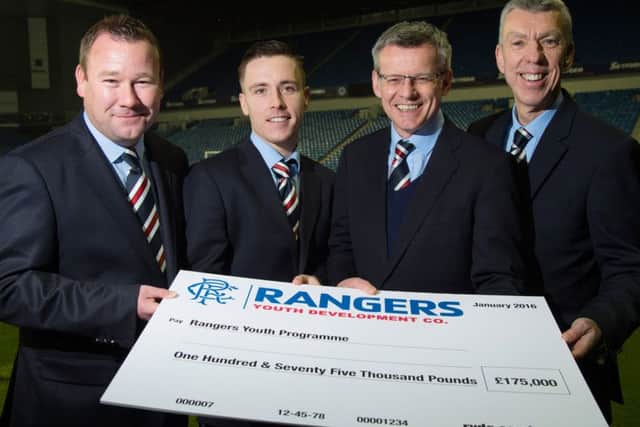 From left, Rangers youth chief Craig Mulholland, Barrie McKay, Rangers MD Stuart Robertson and Colin Stewart, head of Rangers Lottery, with a cheque for Â£175,000. Picture: SNS