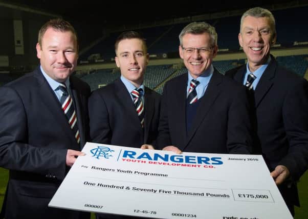 From left, Rangers youth chief Craig Mulholland, Barrie McKay, Rangers MD Stuart Robertson and Colin Stewart, head of Rangers Lottery, with a cheque for Â£175,000. Picture: SNS
