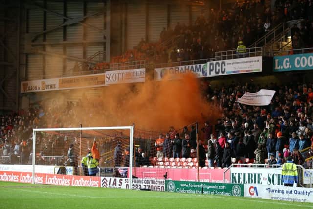 A smoke bomb is let off in the stands during the match with Celtic on Friday. Picture: PA