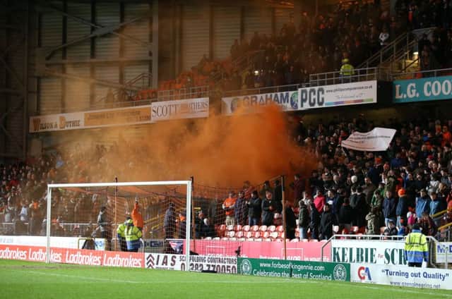 A smoke bomb is let off in the stands during the match with Celtic on Friday. Picture: PA