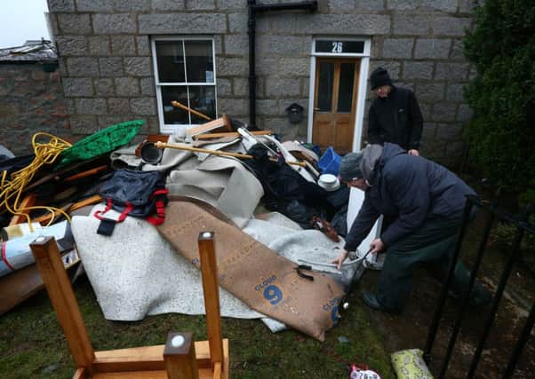 Residents clear flood-damaged furniture from their homes in Ballater after the River Dee burst its banks earlier this month. Picture: Getty Images