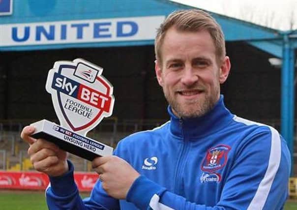 Danny Grainger with the Sky Bet Football League Unsung Hero award. Picture: CUFC Twitter