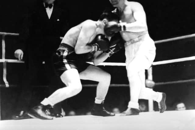 Romanian Aurel Toma ducks as Benny Lynch goes on the attack at the National Sporting Club in London.  Lynch lost the bout by knockout