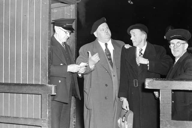 Stan Laurel and Oliver Hardy (Laurel and Hardy) with a ticket collector at the old Caledonian railway station in Edinburgh 13/4/1954.