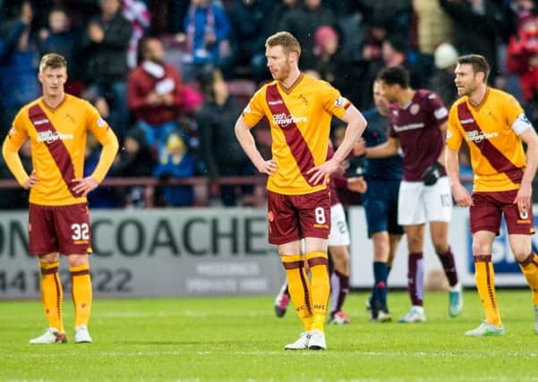 The Motherwell players cut a dejected figure at full-time. Picture: SNS