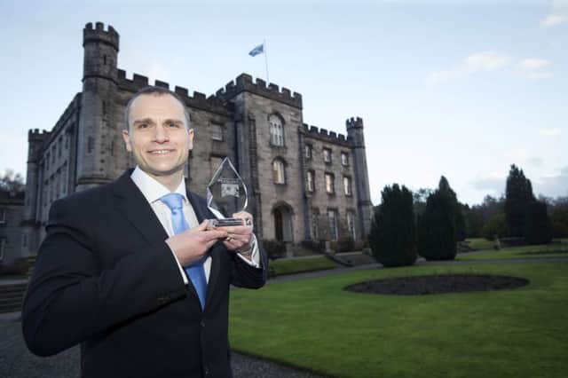 Sergeant Neil Wilson with his award the Police Scotland College. Picture: PA