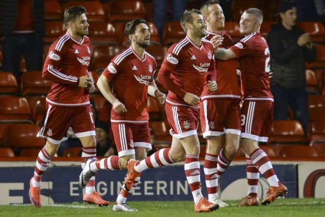 Aberdeen's Adam Rooney (2nd from right) celebrates after scoring what would prove to be the winning goal. Picture: SNS