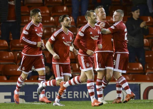 Aberdeen's Adam Rooney (2nd from right) celebrates after scoring what would prove to be the winning goal. Picture: SNS