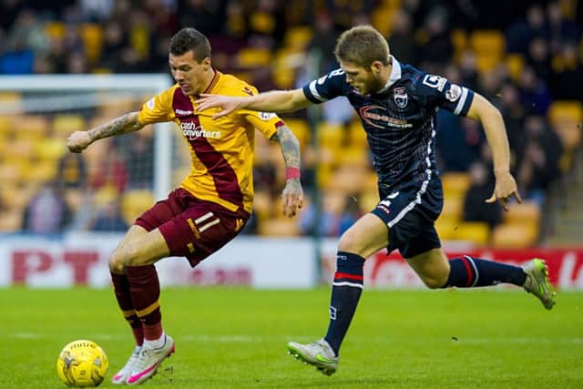 Motherwell's Marvin Johnson (left) battles with Ross County's Marcus Fraser. Picture: SNS