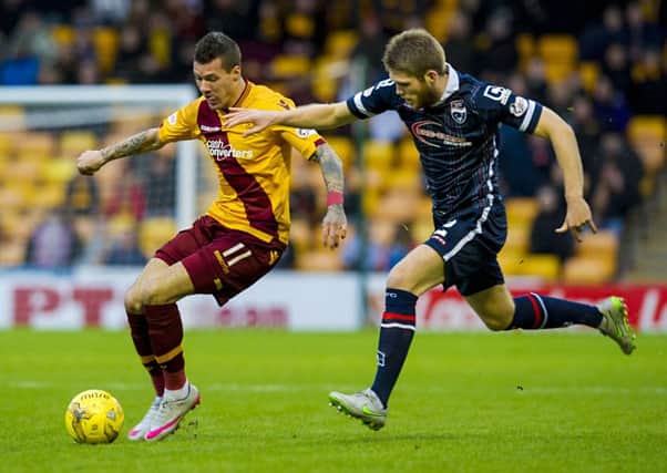 Motherwell's Marvin Johnson (left) battles with Ross County's Marcus Fraser. Picture: SNS