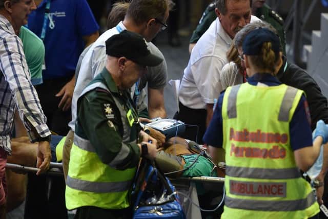 Nigel Sears is stretchered away by paramedics. Picture: AFP/Getty