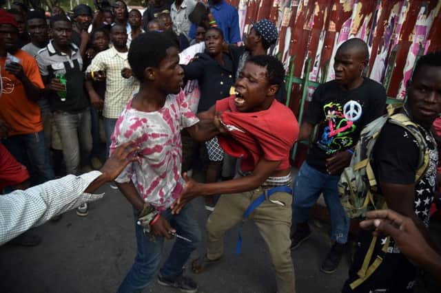 A scuffle breaks out druing protest in Port-au-Prince. Picture: AFP/Getty