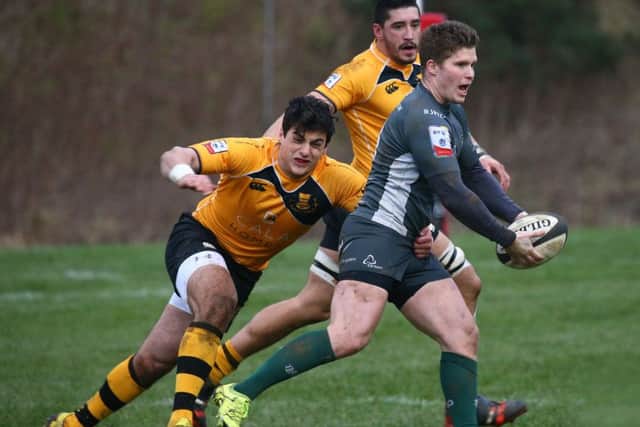 Hawick scrum-half Shaun Goodfellow escapes the clutches of Curries Luke Crosbie. Picture: Gordon Fraser