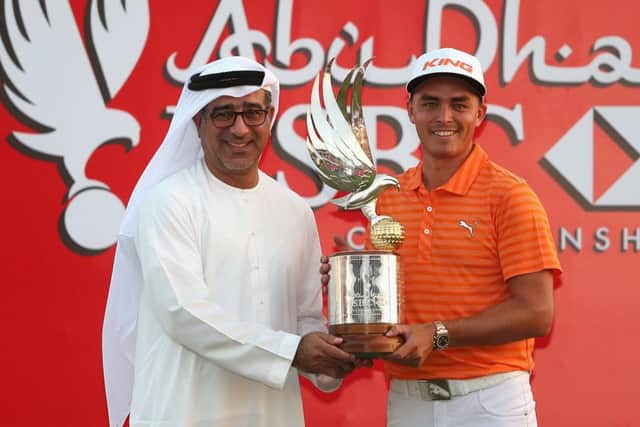 Rickie Fowler poses with the trophy alongside Abdulfattah Sharaf after winning at Abu Dhabi. Picture: Getty