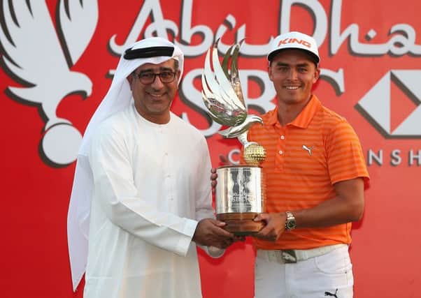 Rickie Fowler poses with the trophy alongside Abdulfattah Sharaf after winning at Abu Dhabi. Picture: Getty
