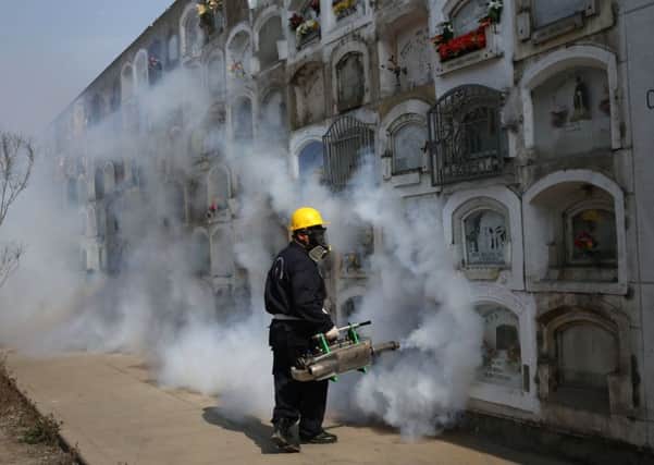 A worker fumigates a ceremony as a precaution against the Zika virus in Lima, Peru. Picture: AP