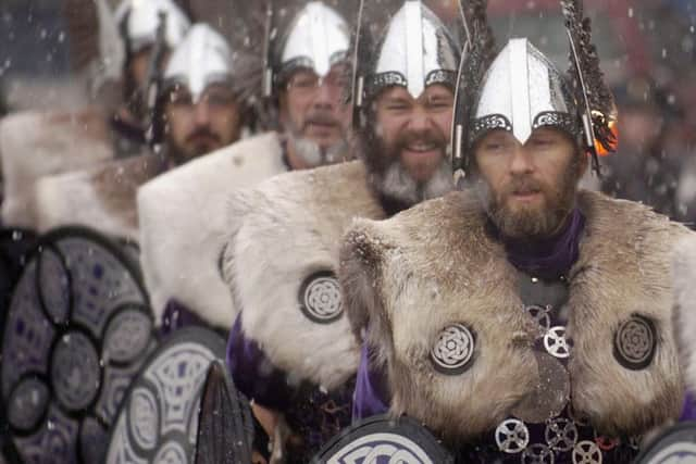 Locals dressed as Vikings brave the snow storms and march through the streets of Lerwick on January 27, 2004, in the Shetland Islands, Scotland.Picture: Chris Furlong/Getty Images