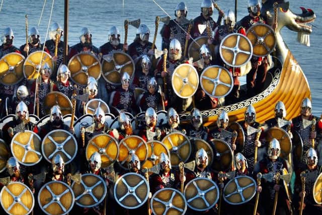 Around 50 men from the Norsemen Jarl Squad arrive at Lerwick harbour on a longboat, Tuesday January 31, 2006, to celebrate Shetland's annual Viking festival Up Helly Aa.