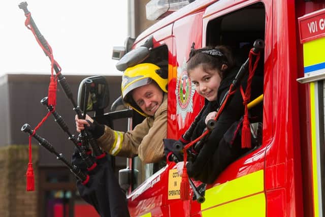 Firefighters, Steven Walls, with Kaylee Clugson from Riverside school, at Govan Fire Station
 Picture: Wullie Marr/HPR